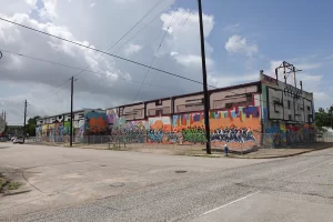 The North facing side of Houston Graffiti Park with walls completely covered in colorful murals by Houston graffiti artists and muralists.